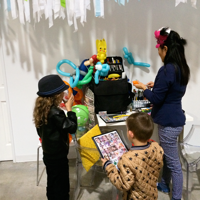 Face painting and balloons kid's activities at Honest Company 2nd birthday